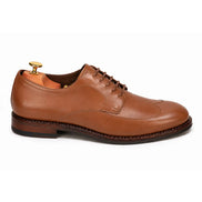 Side profile of the Matador Apron-Toe Derby in tan leather on white background