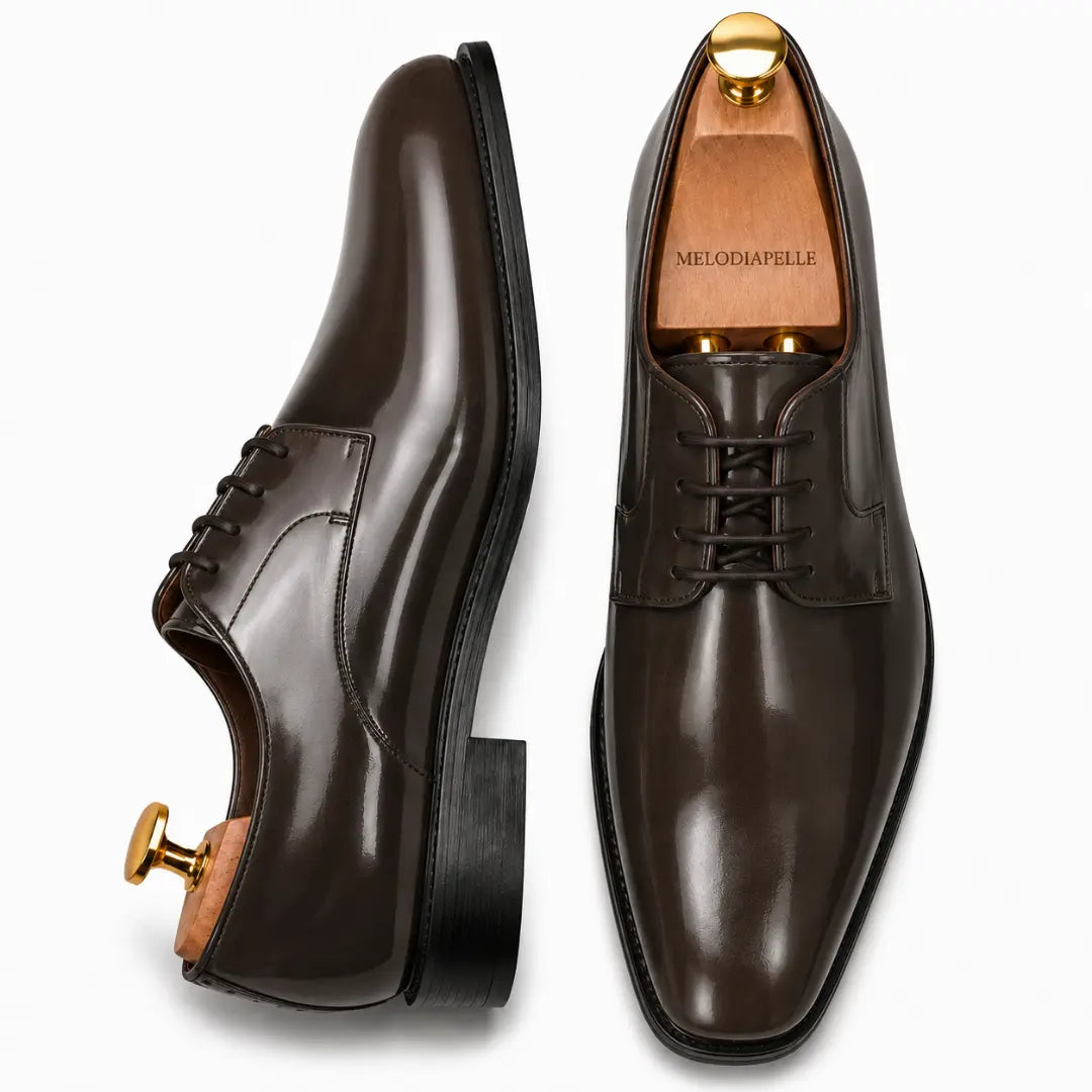 Brown leather plain-toe Derby, three-quarter angle showing heel and glossy finish