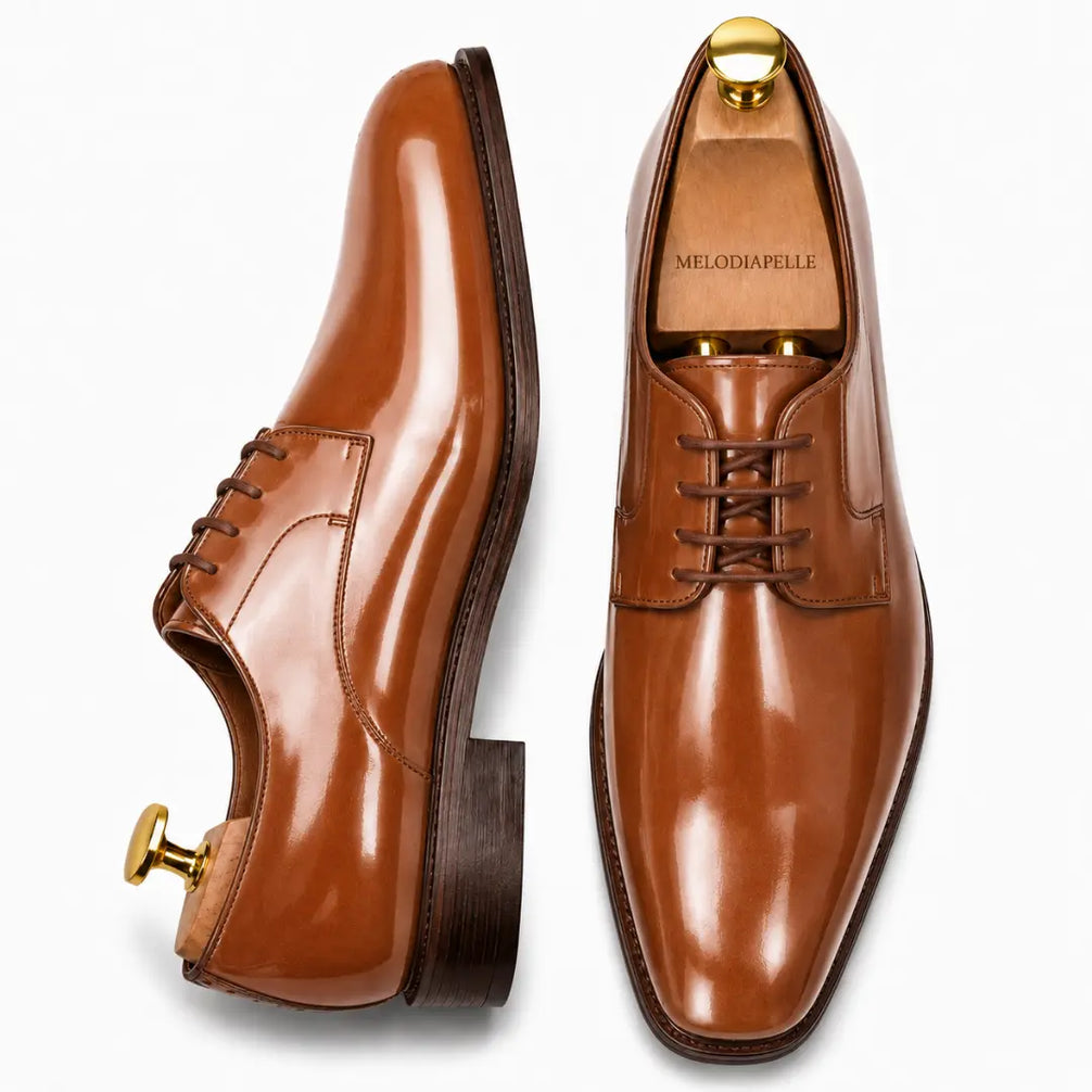 Tan leather plain-toe Derby, three-quarter angle showing heel and glossy finish
