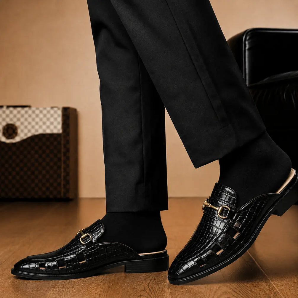 Melodiapelle Matilda Mule in black croc-embossed leather worn with trousers, on-feet shot