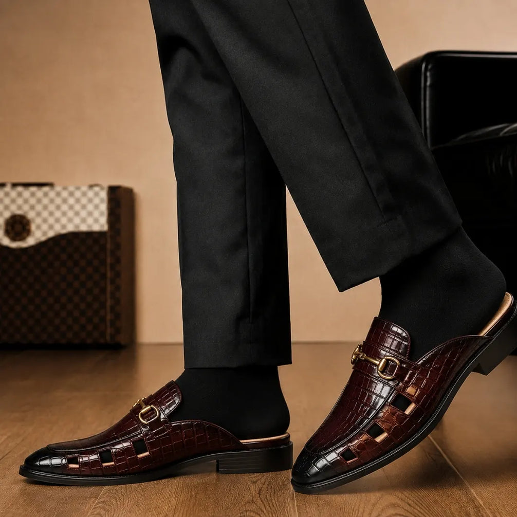 Melodiapelle Matilda Mule in oxblood brown croc-embossed leather worn with trousers, on-feet shot