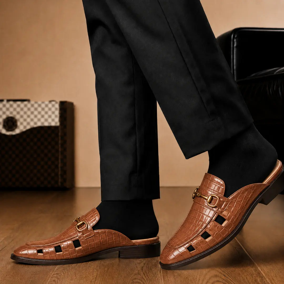 Melodiapelle Matilda Mule in tan croc-embossed leather worn with trousers, on-feet shot