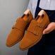 Man holding a pair of Melodiapelle Maverick Double Monk Brogue shoes in camel suede, close-up