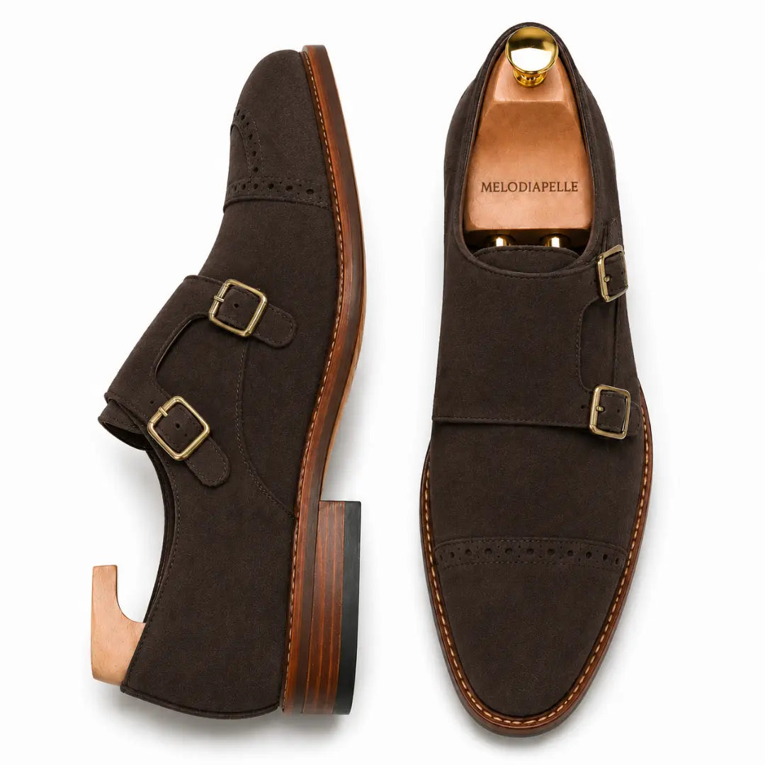 Dark brown suede double monk strap shoe, three-quarter angle showing buckles and heel