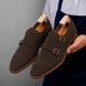 Man holding a pair of Melodiapelle Maverick Double Monk Brogue shoes in dark brown suede, close-up
