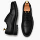 Black leather cap-toe Derby, three-quarter angle showing heel and toe detailing