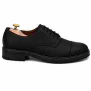 Side profile of the Max Cap Toe Derby in black leather on white background