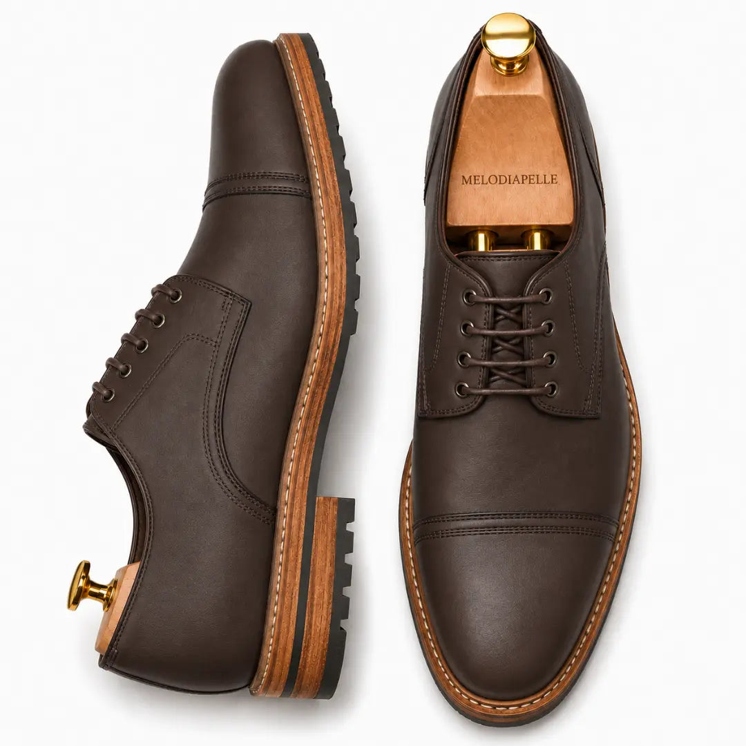 Dark brown leather cap-toe Derby, three-quarter angle showing heel and toe detailing