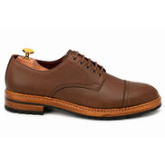Side profile of the Max Cap Toe Derby in mole brown nubuck leather on white background