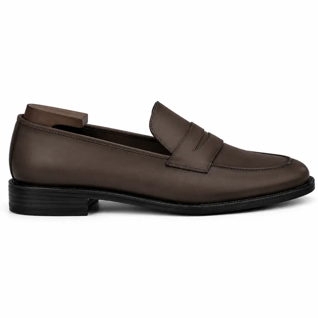 Side profile of the Maximus Dress Penny Loafer in brown leather on white background