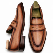 Cognac tan burnished leather penny loafer, three-quarter angle showing heel and penny strap