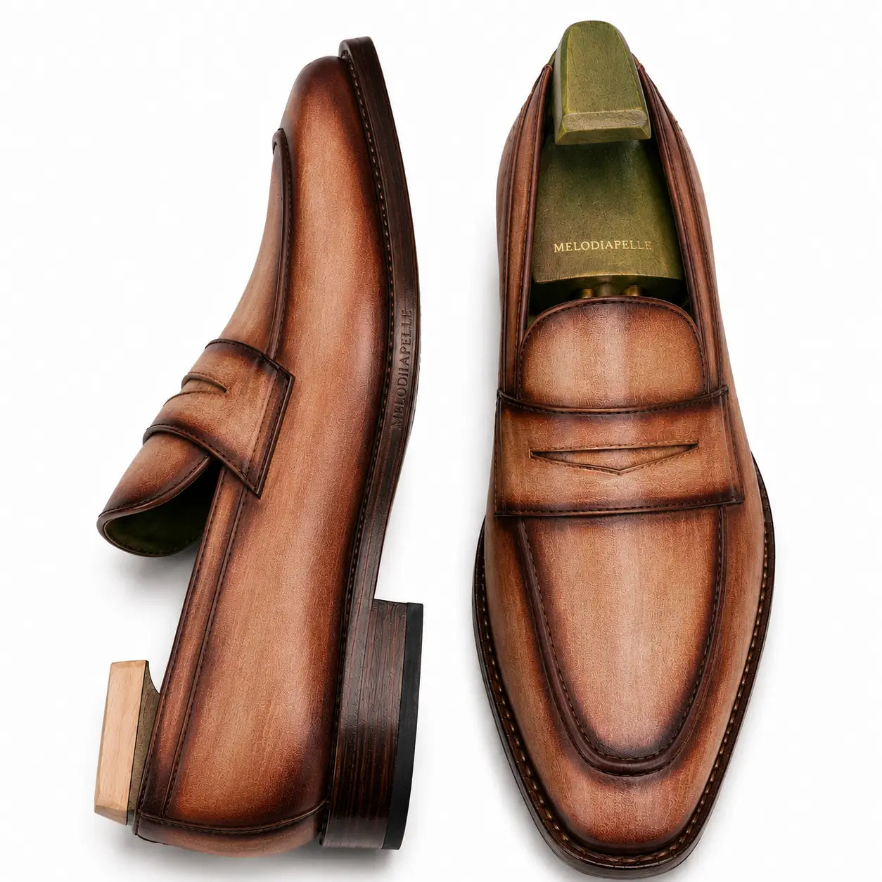 Cognac tan burnished leather penny loafer, three-quarter angle showing heel and penny strap