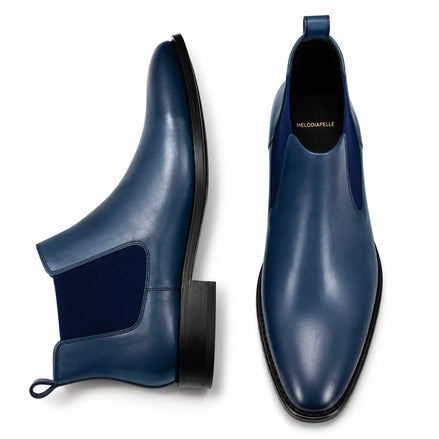 Steel blue leather Chelsea boots, three-quarter angle showing elastic side panel and heel