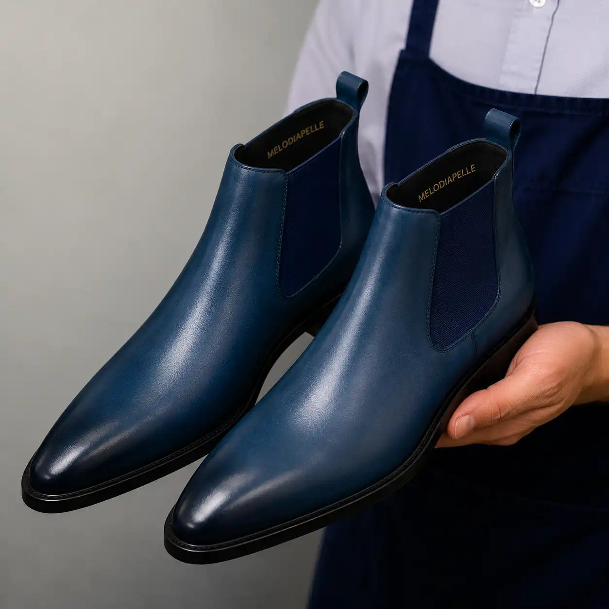 Man wearing Melodiapelle Mazarine Chelsea Boot in steel blue, styled close-up