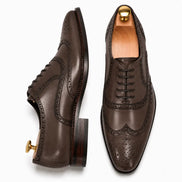 Dark brown leather wingtip brogue Oxford, three-quarter angle showing heel and brogue detailing