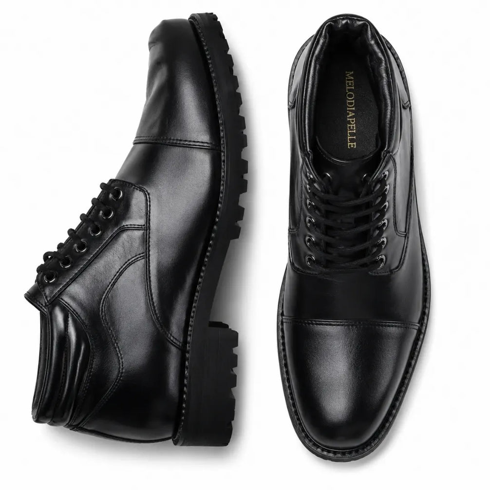 Black leather cap-toe combat boot, three-quarter angle showing heel and sole detailing