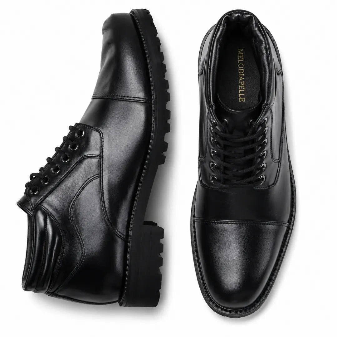 Black leather cap-toe combat boot, three-quarter angle showing heel and sole detailing