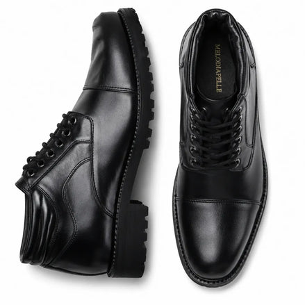 Black leather cap-toe combat boot, three-quarter angle showing heel and sole detailing
