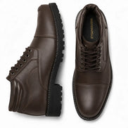 Dark brown leather cap-toe combat boot, three-quarter angle showing heel and sole detailing