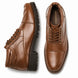 Tan leather cap-toe combat boot, three-quarter angle showing heel and sole detailing