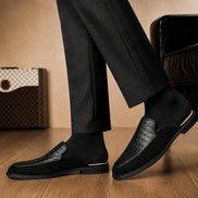 Melodiapelle Mckinsey Mule in black croc-embossed leather worn with formal trousers, on-feet shot