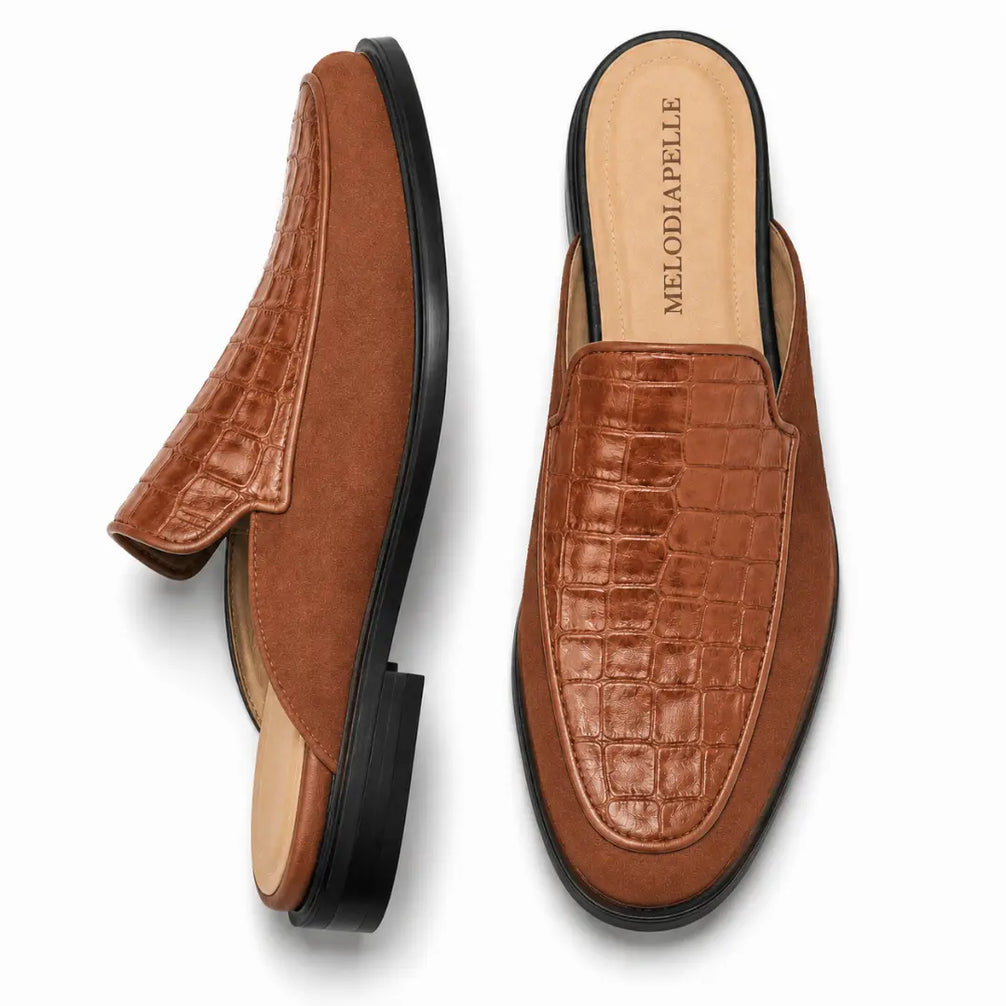Tan croc-embossed leather penny mule, three-quarter angle showing heel and texture detailing
