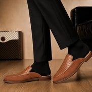 Melodiapelle Mckinsey Mule in tan croc-embossed leather worn with formal trousers, on-feet shot