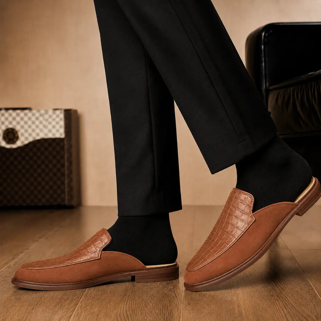 Melodiapelle Mckinsey Mule in tan croc-embossed leather worn with formal trousers, on-feet shot
