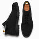 Black suede combat boot, three-quarter angle showing heel and sole detailing