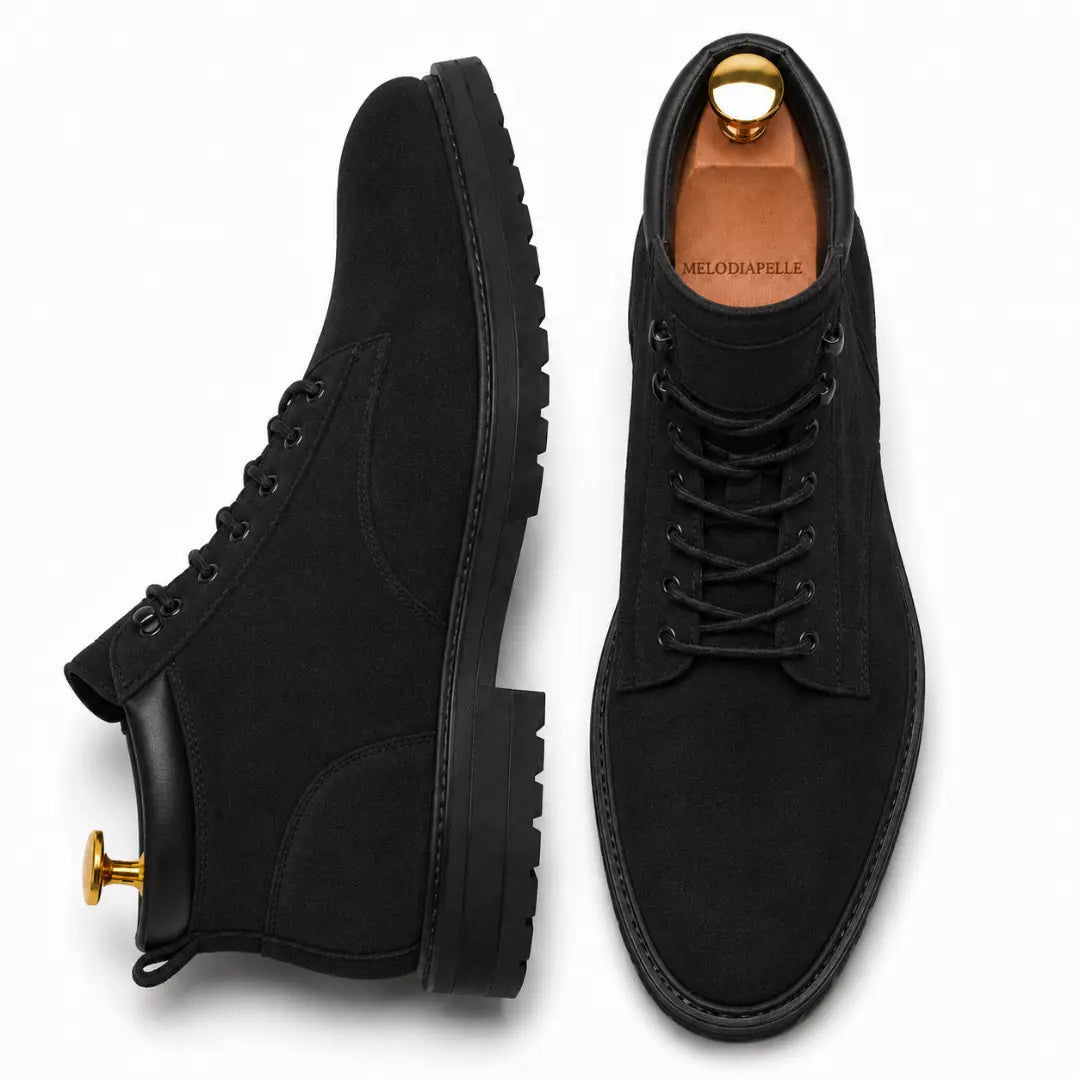 Black suede combat boot, three-quarter angle showing heel and sole detailing