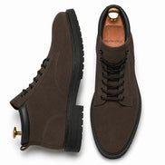 Dark brown suede combat boot, three-quarter angle showing heel and sole detailing