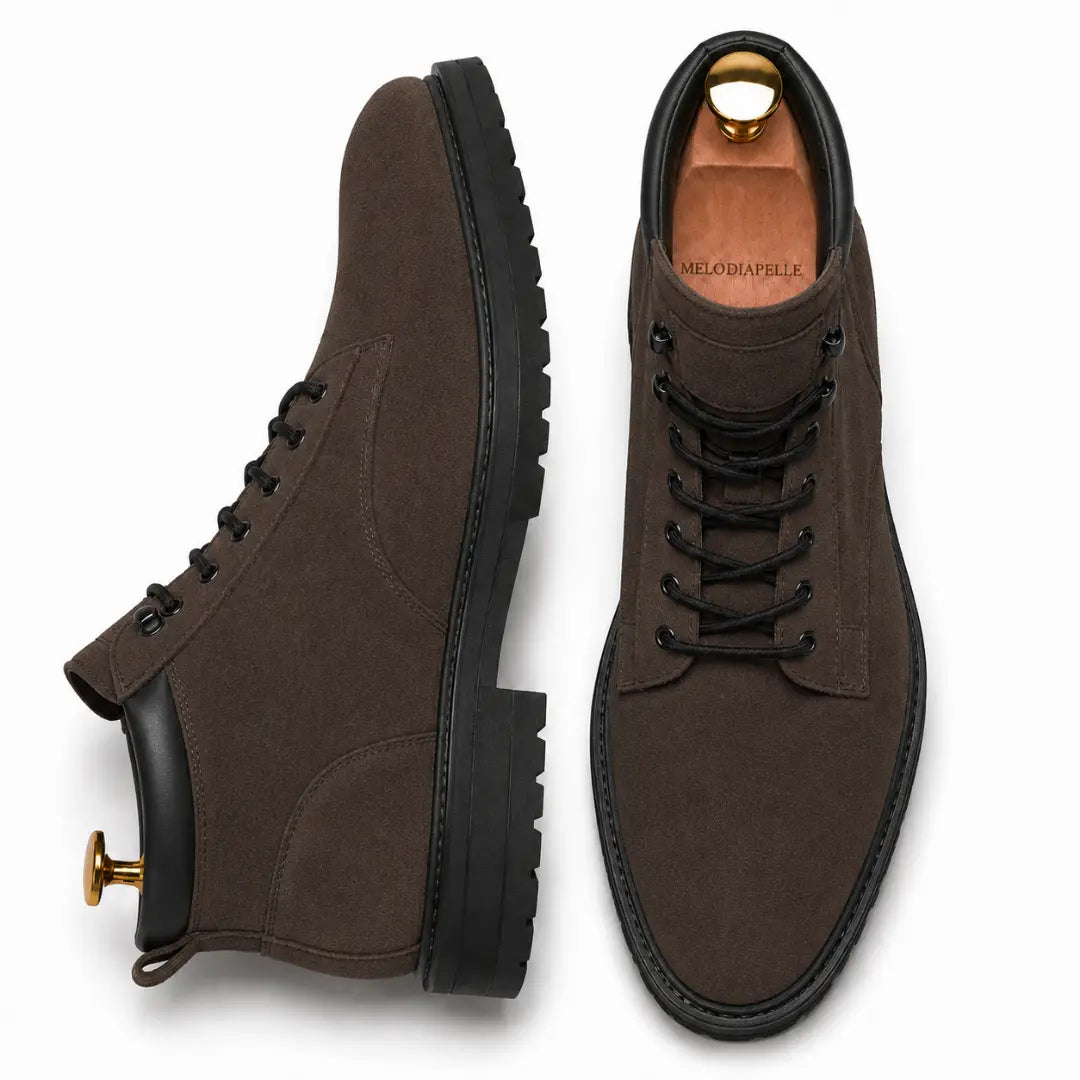 Dark brown suede combat boot, three-quarter angle showing heel and sole detailing