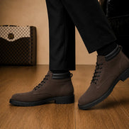 Melodiapelle Meilbourne Combat Boot in dark brown suede worn with trousers, on-feet shot