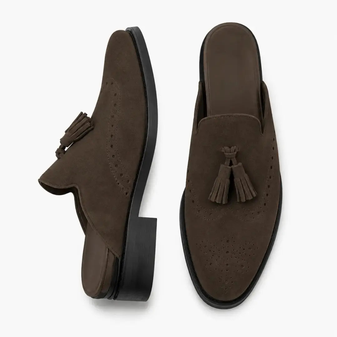 Black suede tassel mule, three-quarter angle showing tassel and heel