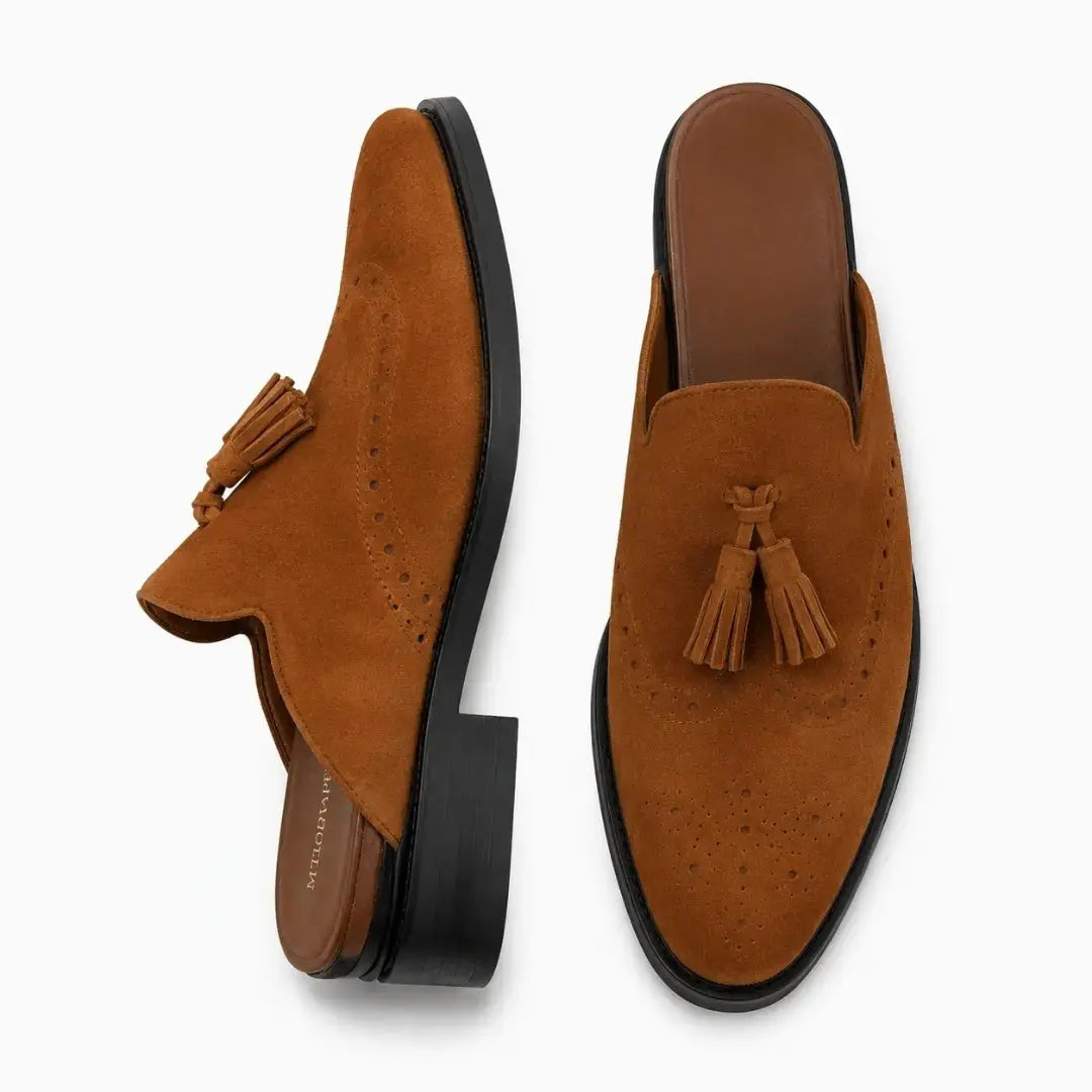 Rust tan suede tassel mule, three-quarter angle showing tassel and heel