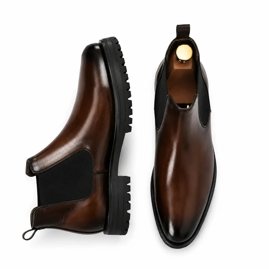 Dark brown leather Chelsea boot, three-quarter angle showing heel and sole detailing