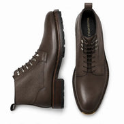 Dark brown leather combat boot, three-quarter angle showing heel and sole detailing