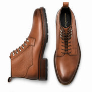 Tan leather combat boot, three-quarter angle showing heel and sole detailing