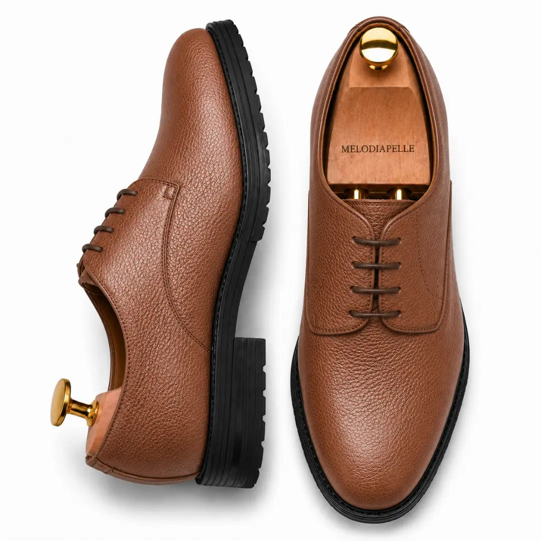Tan leather plain-toe Derby, three-quarter angle showing heel and sole detailing