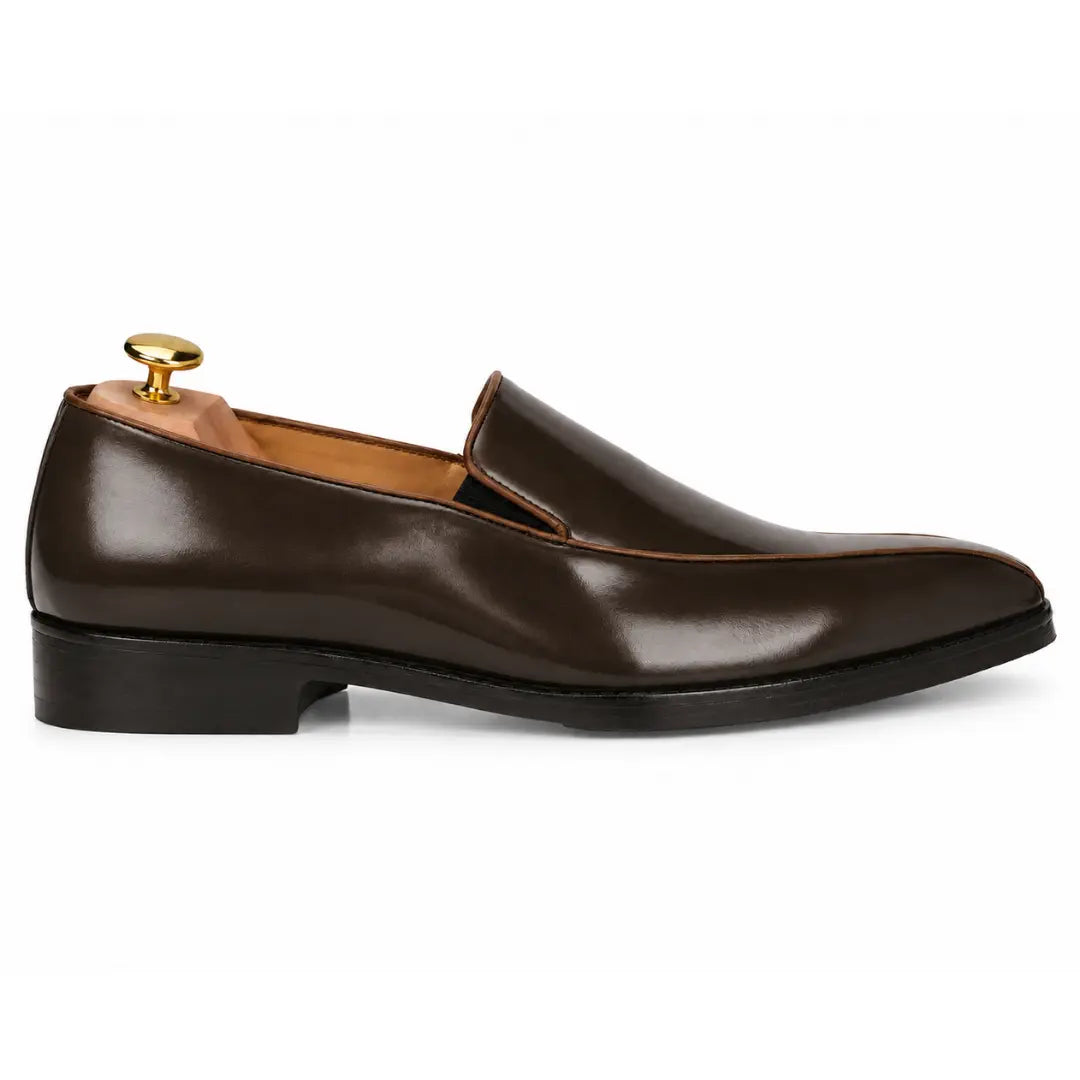 Side profile of the Merlot Dress Loafer in brown leather on white background