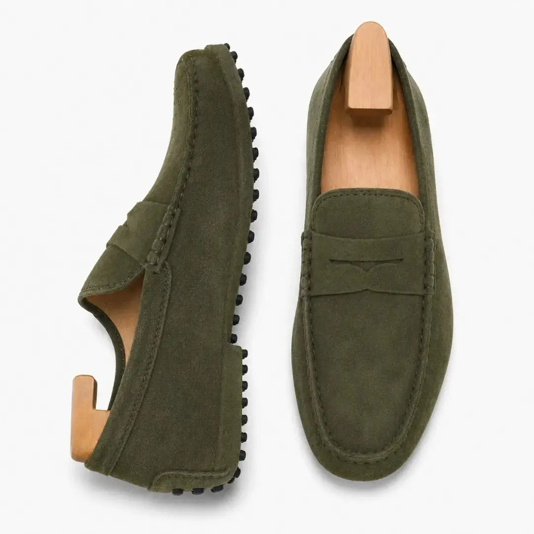 Olive green suede penny loafer, three-quarter angle showing sole detailing