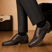 Melodiapelle Meta Semi-Brogue Oxford in dark brown leather worn with formal trousers, on-feet shot