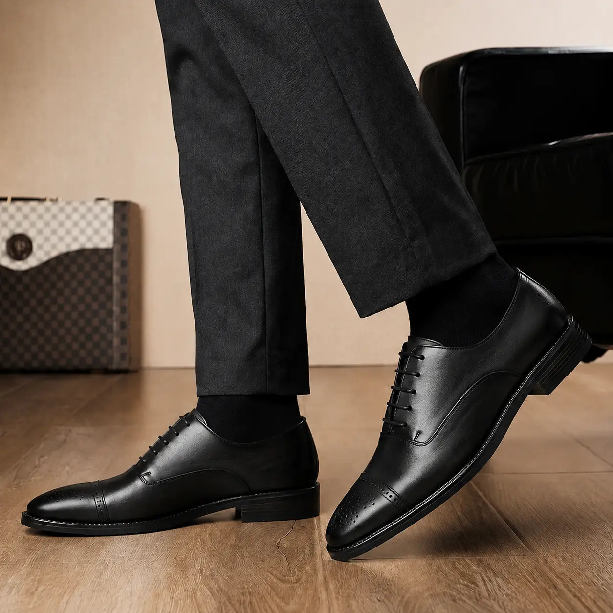 Melodiapelle Meta Wholecut Oxford in black leather worn with formal trousers, on-feet shot
