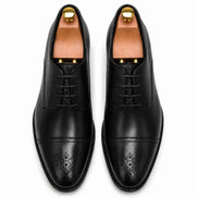 Melodiapelle Meta Wholecut Oxford in black leather, pair top-down view, handcrafted in Agra