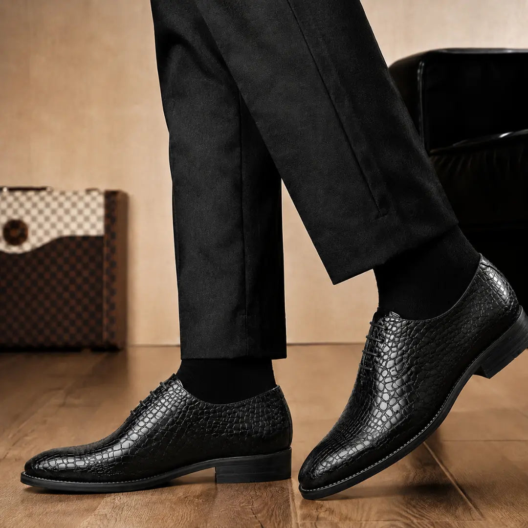 Melodiapelle Meta Wholecut Oxford in black croc-embossed leather worn with formal trousers, on-feet shot