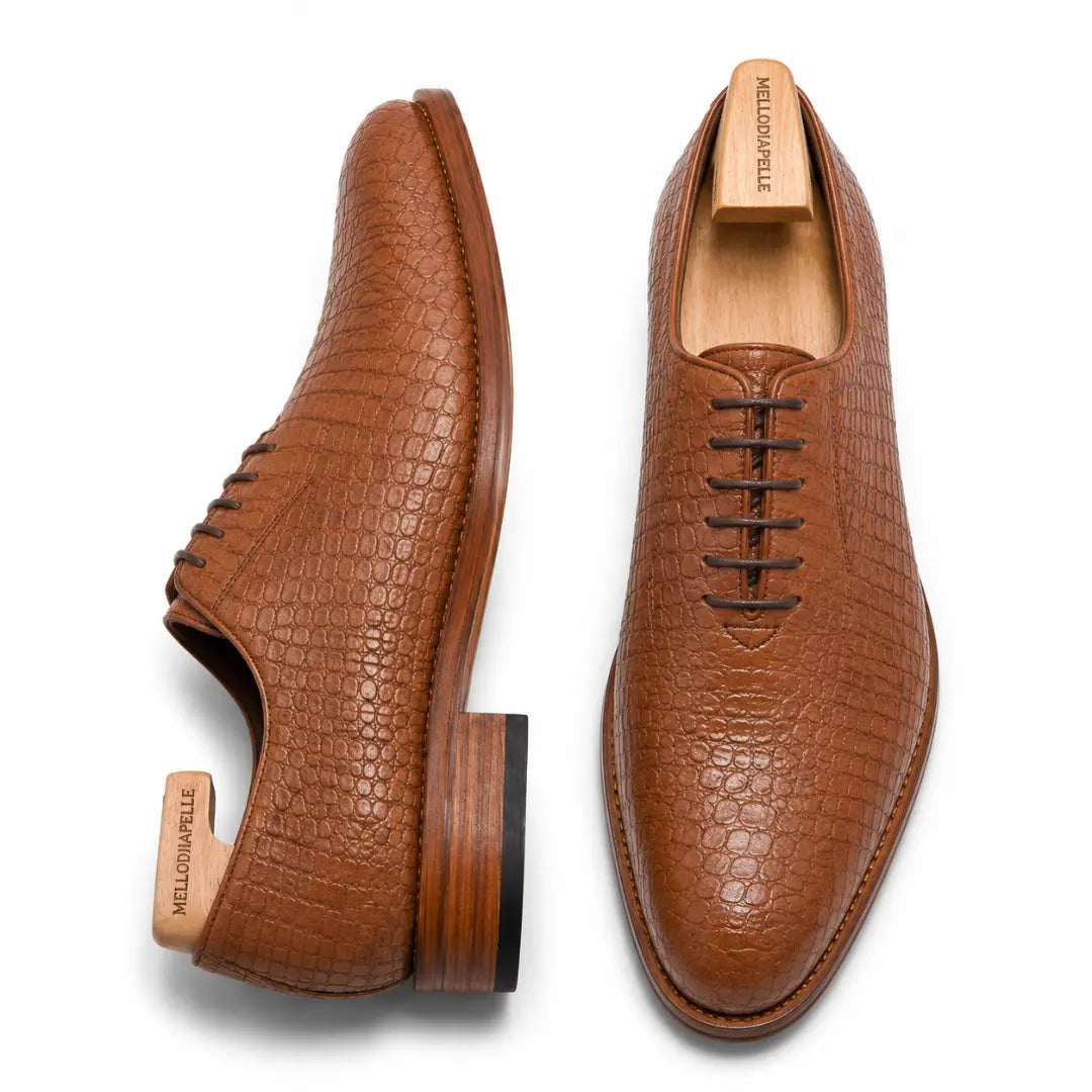 Tan croc-embossed leather wholecut Oxford, three-quarter angle showing heel and texture detailing
