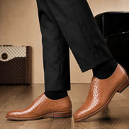 Melodiapelle Meta Wholecut Oxford in tan croc-embossed leather worn with formal trousers, on-feet shot