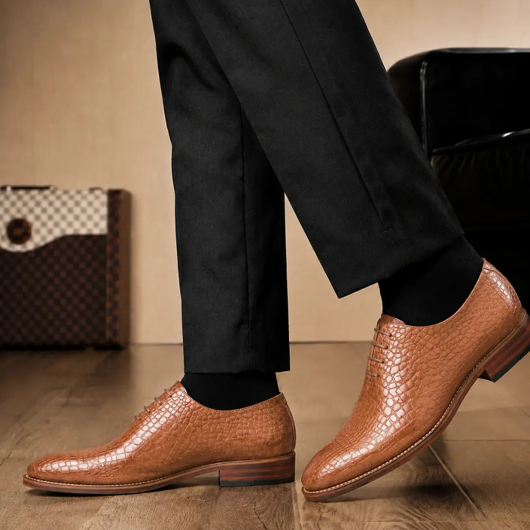 Melodiapelle Meta Wholecut Oxford in tan croc-embossed leather worn with formal trousers, on-feet shot