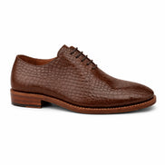 Side profile of the Meta Wholecut Oxford in taupe brown croc-embossed leather on white background