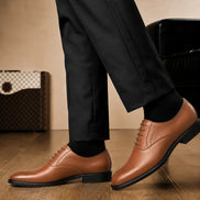 Melodiapelle Meta Wholecut Oxford in tan leather worn with formal trousers, on-feet shot